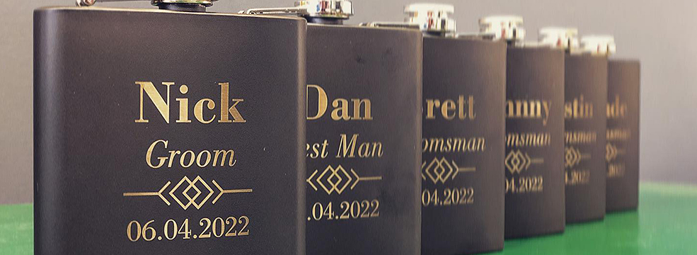 a set of laser engraved flasks personalized for a wedding party